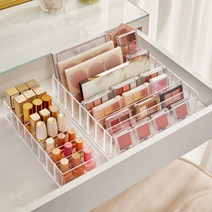 Clear acrylic makeup organizer set for lipstick and eyeshadow inside a white drawer