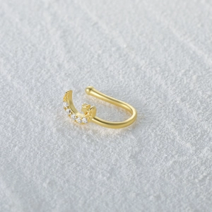 Detailed view of gold star and moon nose cuff with sparkling inlaid crystals
