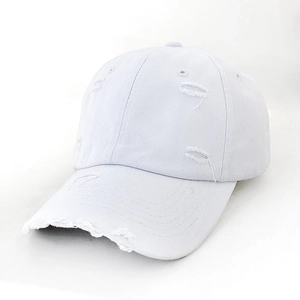 Detailed view of white vintage baseball cap showing distressed torn fabric and soft brim