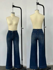 Detailed front and back view of high waist dark blue flare jeans with washed texture