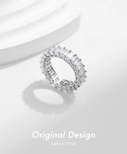 Macro shot of S925 silver eternity ring featuring baguette-cut sparkling crystals