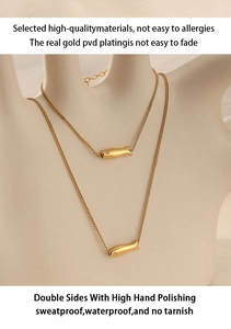 Detail of gold double-layered fish necklace with high-quality PVD plating on hand
