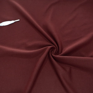 Macro shot of dark red mesh fabric texture with white drawstrings on hooded vest