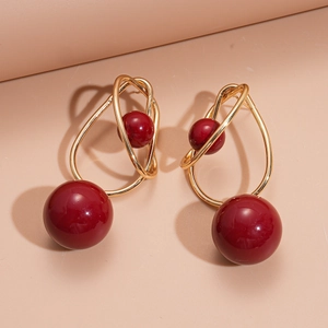Geometric acrylic earrings with red round beads and interlaced golden metal loops