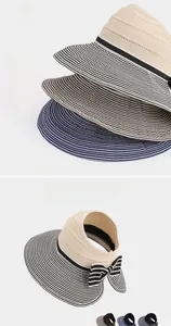 Detail of striped sun visor hat with decorative bow and woven texture for summer