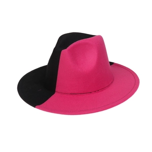 Close-up of dual-tone pink and black fedora hat with felt texture and wide brim