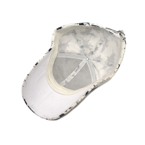 Macro detail of the white lining and reinforced stitching inside the tie-dye baseball cap