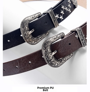 Detail of PU leather belts with silver star studs and vintage engraved buckles