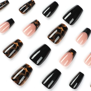French tip tortoise shell press-on nails in medium coffin shape with black leopard pattern