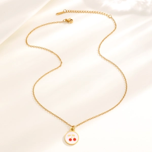 Close-up of golden stainless steel necklace with round cherry pendant and lobster clasp