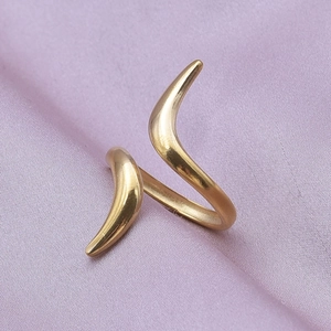 Macro detail of adjustable gold-plated 304 stainless steel ring on purple silk