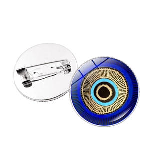 Detailed front and back view of a round Turkish evil eye brooch pin with silver metal fastener