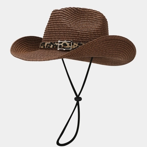 Detail of woven straw Panama hat featuring leopard print belt buckle and chin strap