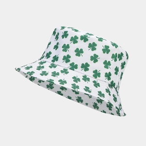 Close-up detail of white bucket hat featuring all-over green shamrock print