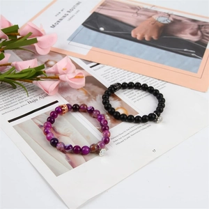 Matching couple bracelets with natural agate beads, magnetic charms, and crown charms