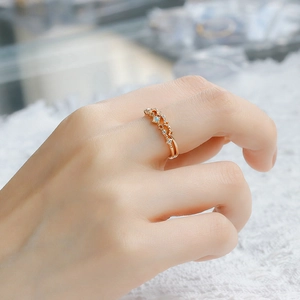 Close-up of vintage style 14K gold plated ring set featuring opal and zircon stones