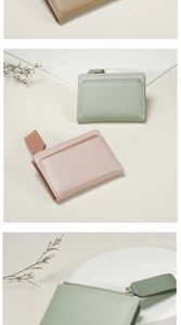 Detail of compact cross-grain leather wallets in sage green and soft pink colors