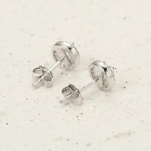 Macro shot of S925 sterling silver round stud earrings with sparkling zircon stones