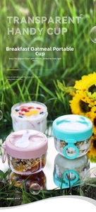 Pink and mint green portable breakfast oat cups with spoons on a sunny outdoor lawn