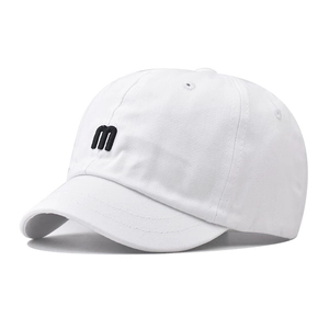 Close-up of black 'm' 3D embroidery on a premium white cotton short-brim baseball cap