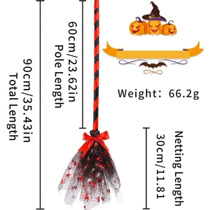 Detail of Halloween witch broom with red ribbon bow and spider net pattern on black mesh