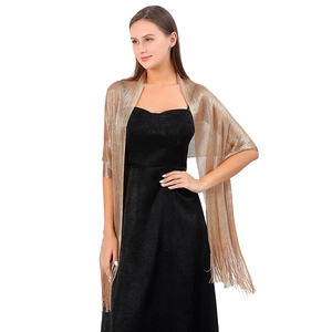 Detail view of gold metallic thread evening shawl with elegant fringe and sheer texture