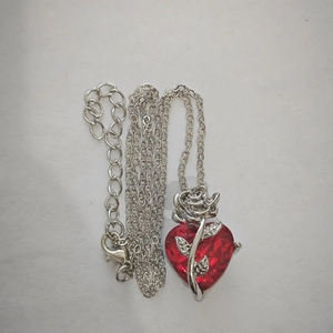 Detail of red heart gemstone necklace with silver rose design and adjustable O-chain