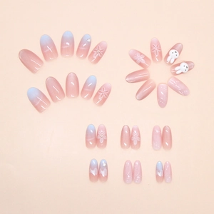 Detail of pink cat-eye press-on nails with 3D white flowers and cute rabbit charms