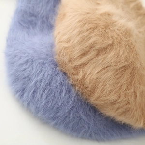 Detailed close-up of blue and camel long faux fur texture on warm winter bucket hats