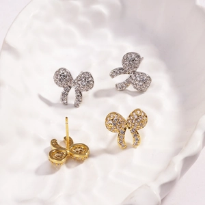 Sparkling pink cubic zirconia bow heart earrings in silver and gold metal finishes