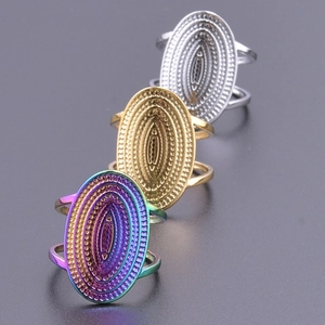 Detailed view of three textured rings in rainbow, gold, and silver stainless steel