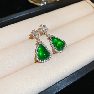 Detailed view of green glass gourd earrings with silver inlay and cubic zirconia stones
