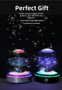 Macro shot of 3D laser engraved solar system crystal ball with glowing LED base