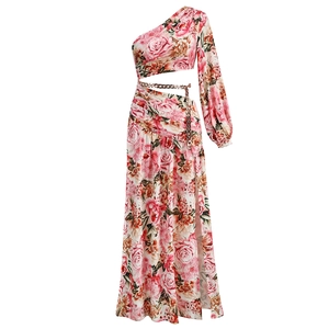 Detail of pink floral one-shoulder maxi dress with waist cutout and metal chain link