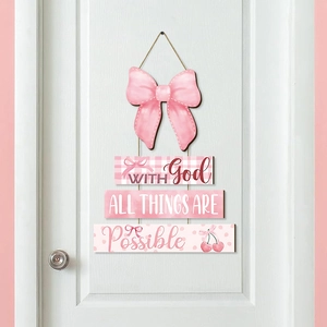 Pink wooden door sign with cherry bow and With God All Things Are Possible quote