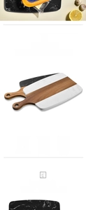 Detail of marble and acacia wood cutting board with handle and round hanging hole