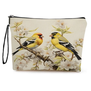 Spring cosmetic bag featuring bird print on linen canvas with a zipper and wristlet