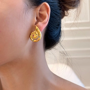 Retro golden snail spiral stud earrings with colorful zircon stones worn on ear