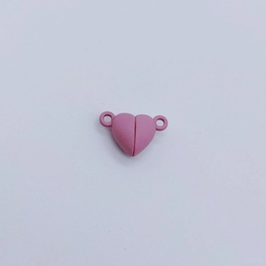 Close-up of pink heart-shaped magnetic clasp connectors for DIY jewelry making