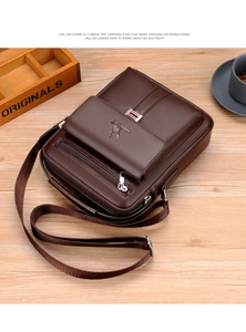 Detail view of deep brown litchi pattern leather messenger bag with multi-zipper pockets