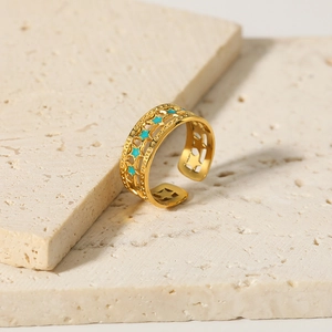 18K gold plated stainless steel open ring with blue enamel star detail on travertine