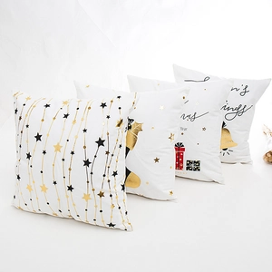 Modern white Christmas pillow covers with gold and black holiday patterns for decor
