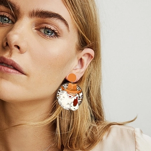 Cowboy Santa Claus earrings with orange leopard print pattern on large round pendants