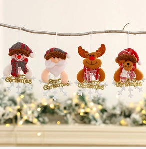 Detail of four plush Christmas ornaments with Merry Christmas signs on a branch