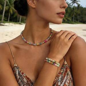 Colorful natural stone beaded necklace and bracelet set worn by a model at the beach