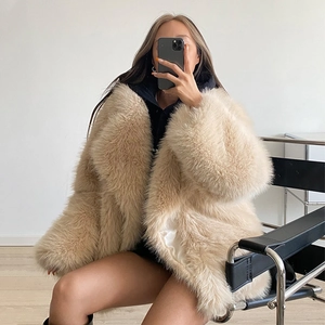 Detailed texture of apricot faux fur coat showing plush fibers and soft draped material