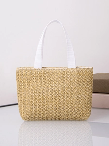 Close-up of hand-woven straw tote bag texture and reinforced white canvas handles