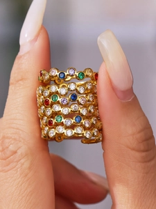 Macro shot of 18K gold plated rings stacked with vibrant multi-colored zircon stones