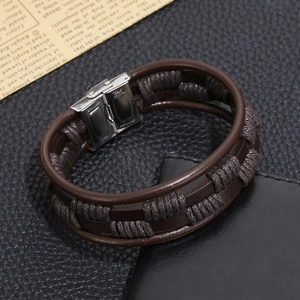 Detail of multi-layer brown braided leather bracelet with stainless steel magnetic clasp