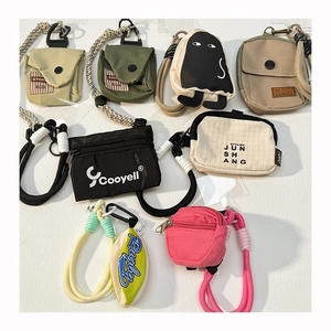 Flat lay of colorful canvas mini pouches, coin purses, and earphone cases with lanyards